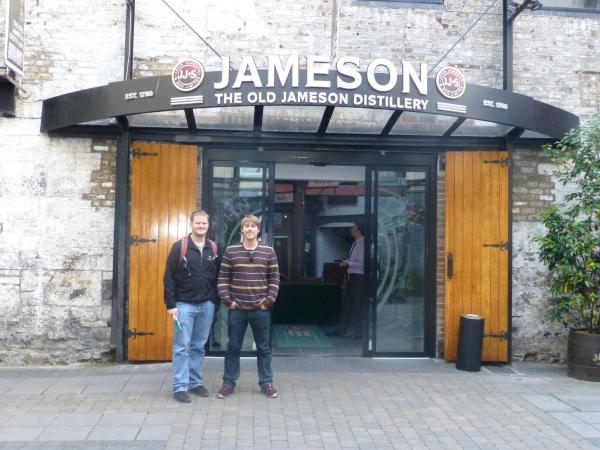 photo of two men in front of the Jameson Distillery